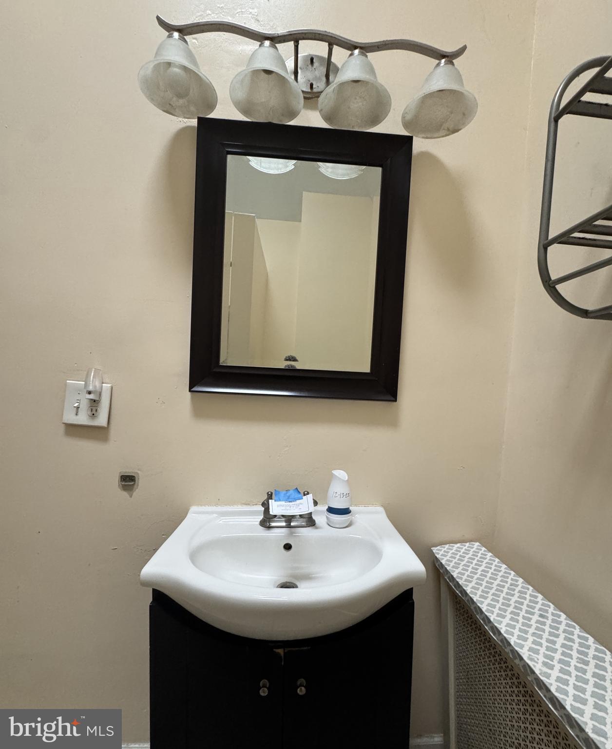 4935 Pulaski Avenue Philadelphia, PA 19144 - Photo 20 of 22 a bathroom with a sink and a mirror