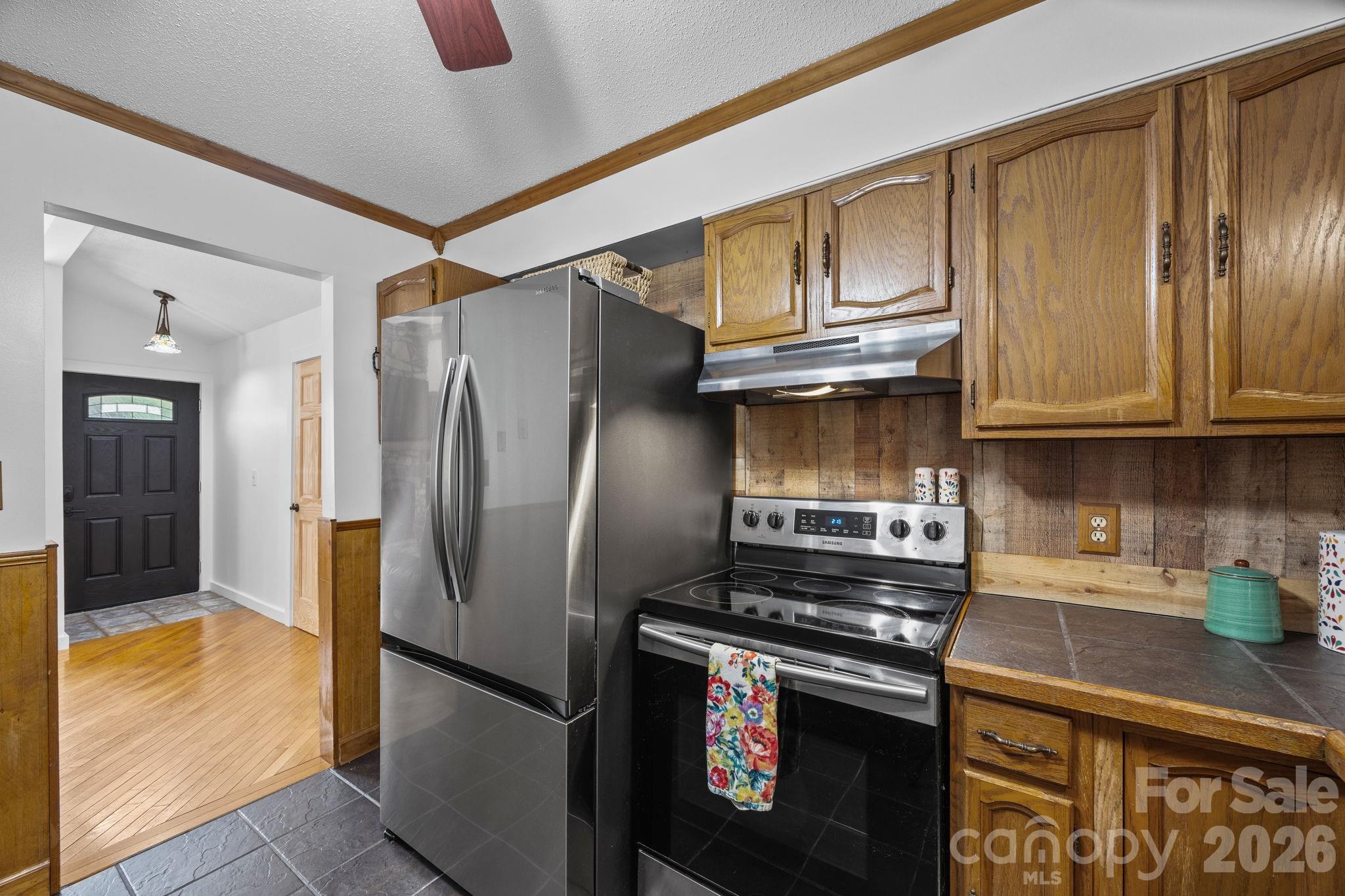 263 Morgan Branch Road, Unit 1 Leicester, NC 28748 - Photo 11 of 31 a kitchen with stainless steel appliances granite countertop a refrigerator a stove and a sink with granite countertops