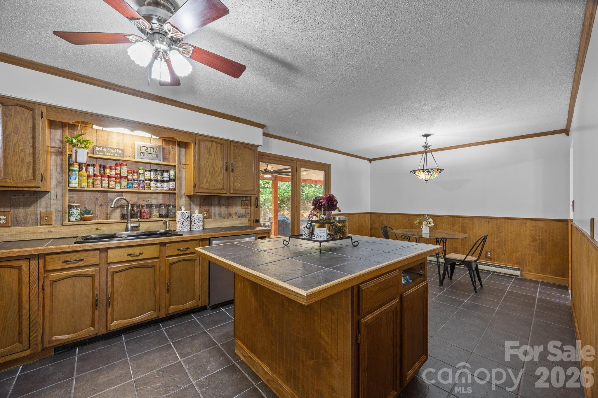 263 Morgan Branch Road, Unit 1 Leicester, NC 28748 - Photo 13 of 31 a kitchen with a stove a sink a dining table and chairs with wooden floor