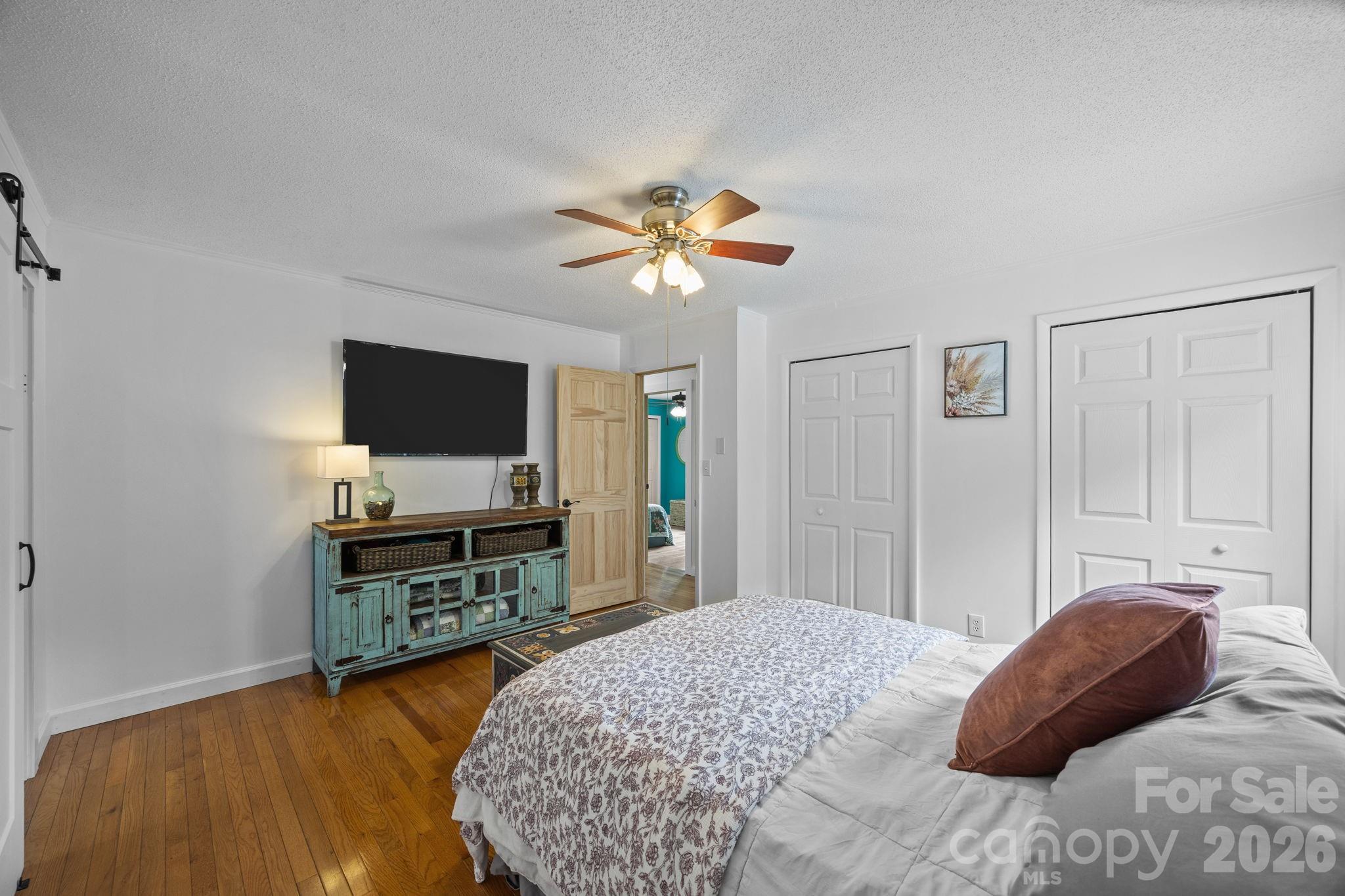 263 Morgan Branch Road, Unit 1 Leicester, NC 28748 - Photo 15 of 31 a bedroom with a bed and a flat screen tv