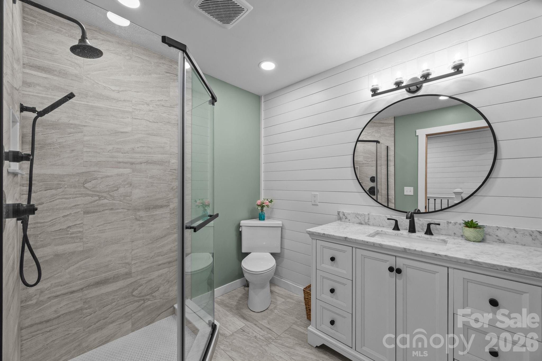 263 Morgan Branch Road, Unit 1 Leicester, NC 28748 - Photo 20 of 31 a bathroom with a sink mirror and toilet