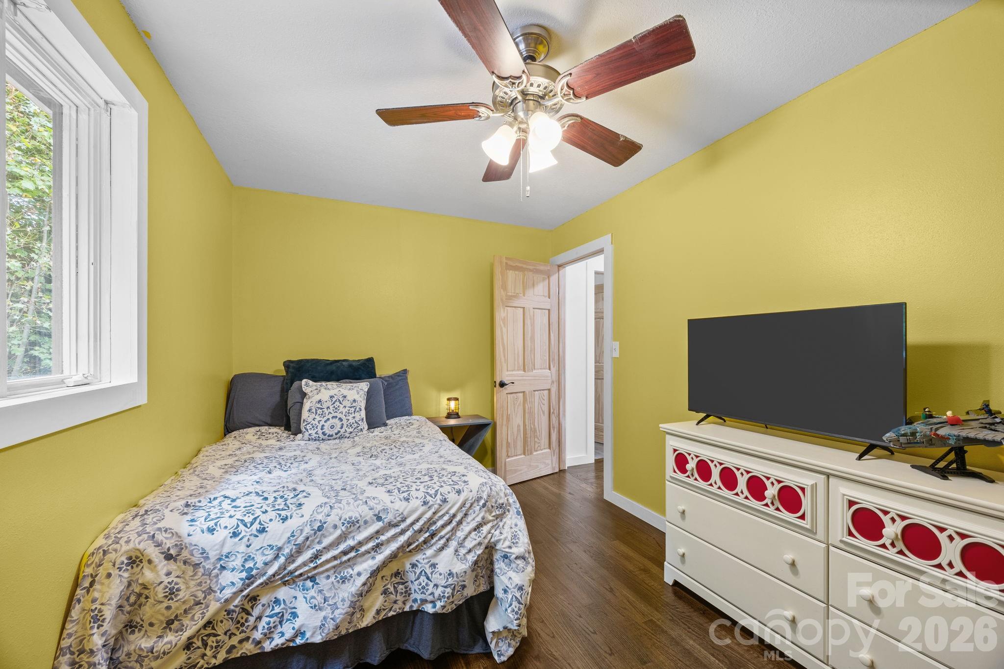 263 Morgan Branch Road, Unit 1 Leicester, NC 28748 - Photo 21 of 31 a bedroom with a bed and flat screen tv
