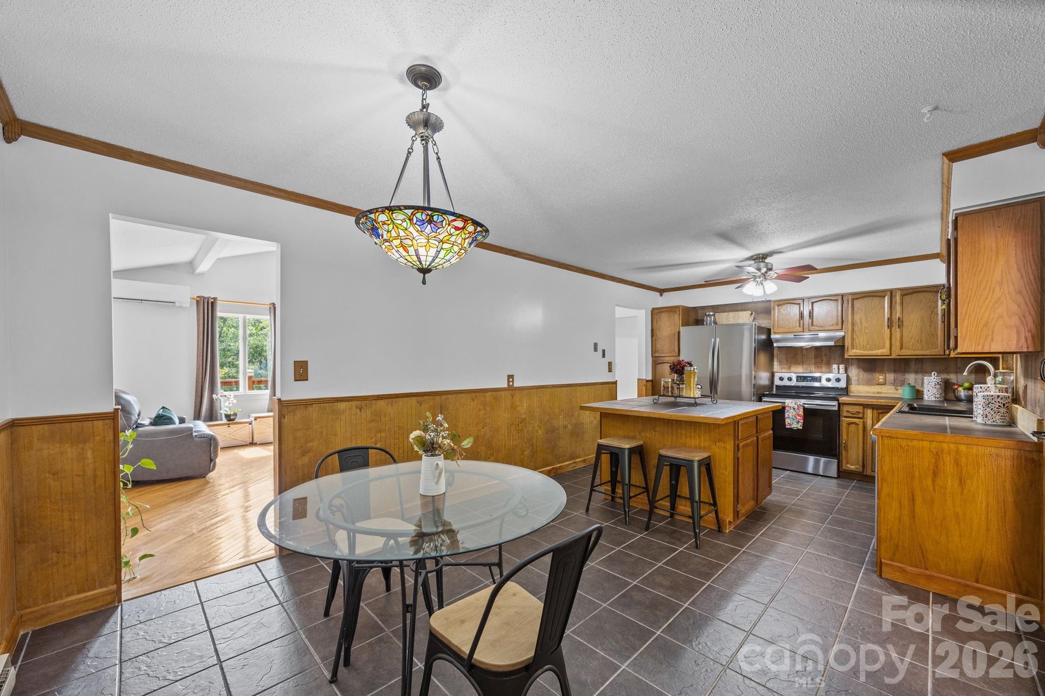 263 Morgan Branch Road, Unit 1 Leicester, NC 28748 - Photo 9 of 31 a view of a dining room with furniture and chandelier