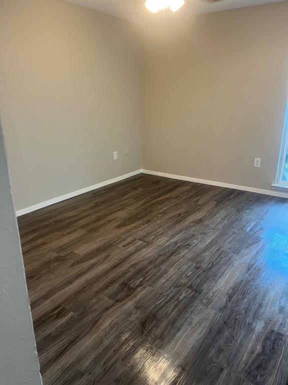 9696 Walnut Street, Unit 303 Dallas, TX 75243 - Photo 3 of 3 a view of an empty room with wooden floor