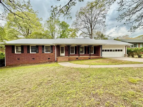 a front view of a residential apartment building with a yard
