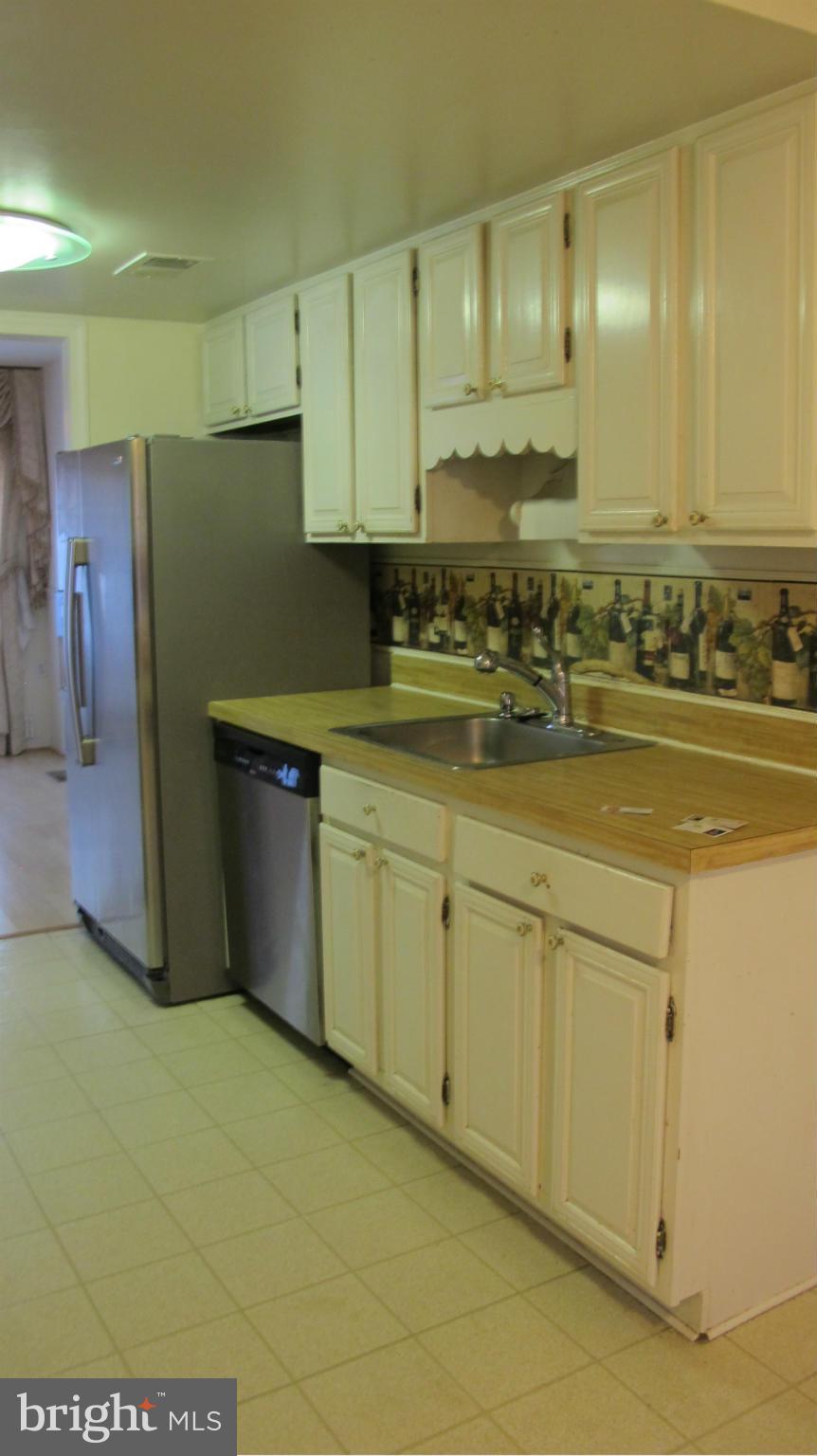2902 Seminole Road Woodbridge, VA 22192 - Photo 19 of 24 a view of a kitchen with stainless steel appliances granite countertop a sink and cabinets