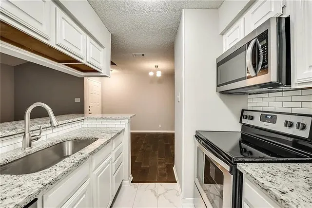 a kitchen with a stove and a microwave