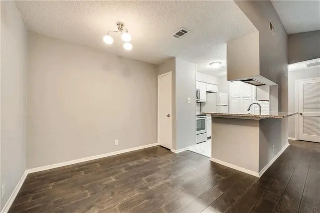 a view of a kitchen with a sink and cabinets