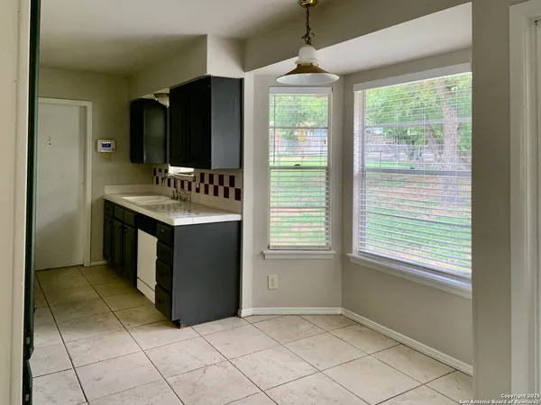a kitchen with stainless steel appliances granite countertop a stove and a refrigerator
