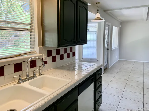a view of a kitchen with refrigerator and microwave