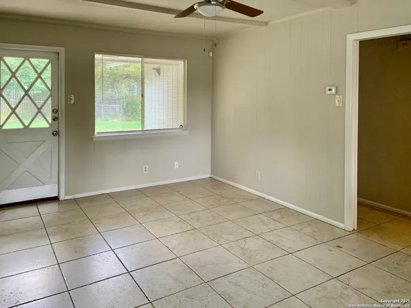 a view of an empty room with a window