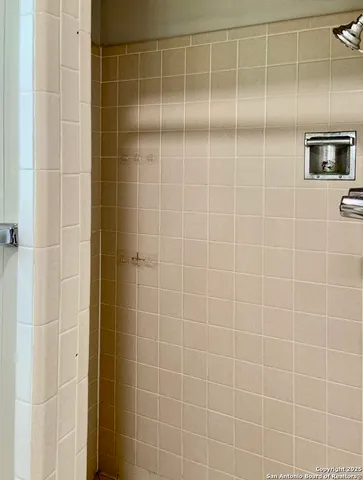 an empty room with a ceiling fan and a window