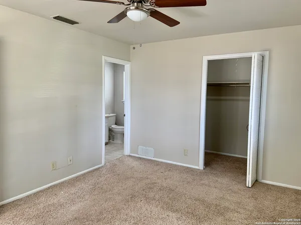 an empty room with windows and closet