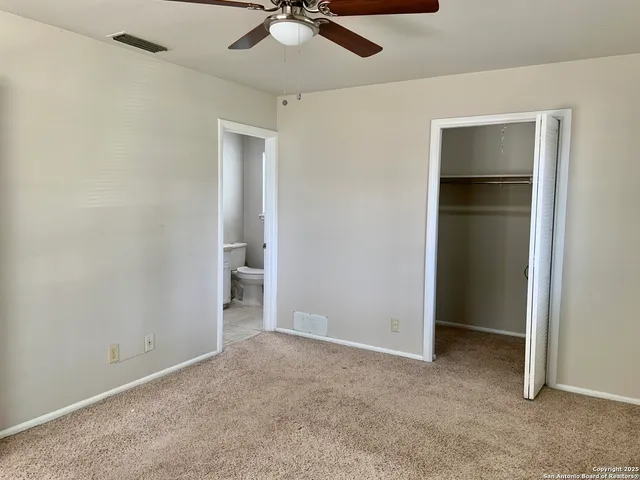 an empty room with windows and closet