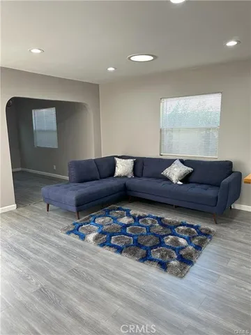 a living room with lots of furniture and a wooden floor