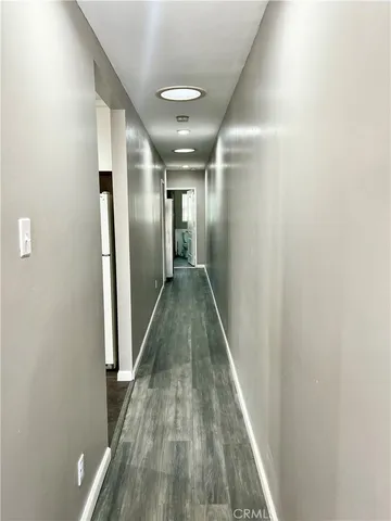 a view of hallway with wooden floor