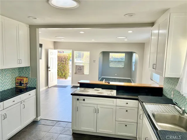 a kitchen with a sink and cabinets