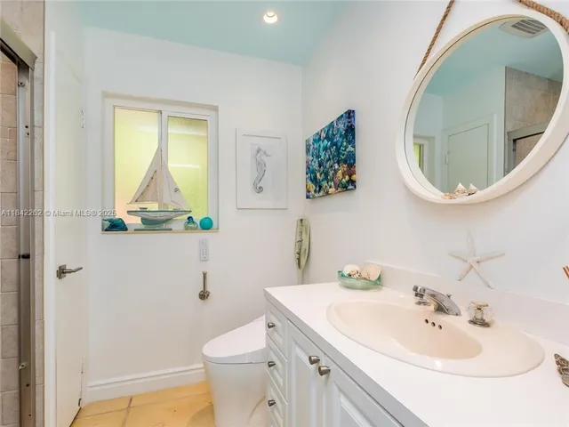 a bathroom with a sink a mirror and toilet
