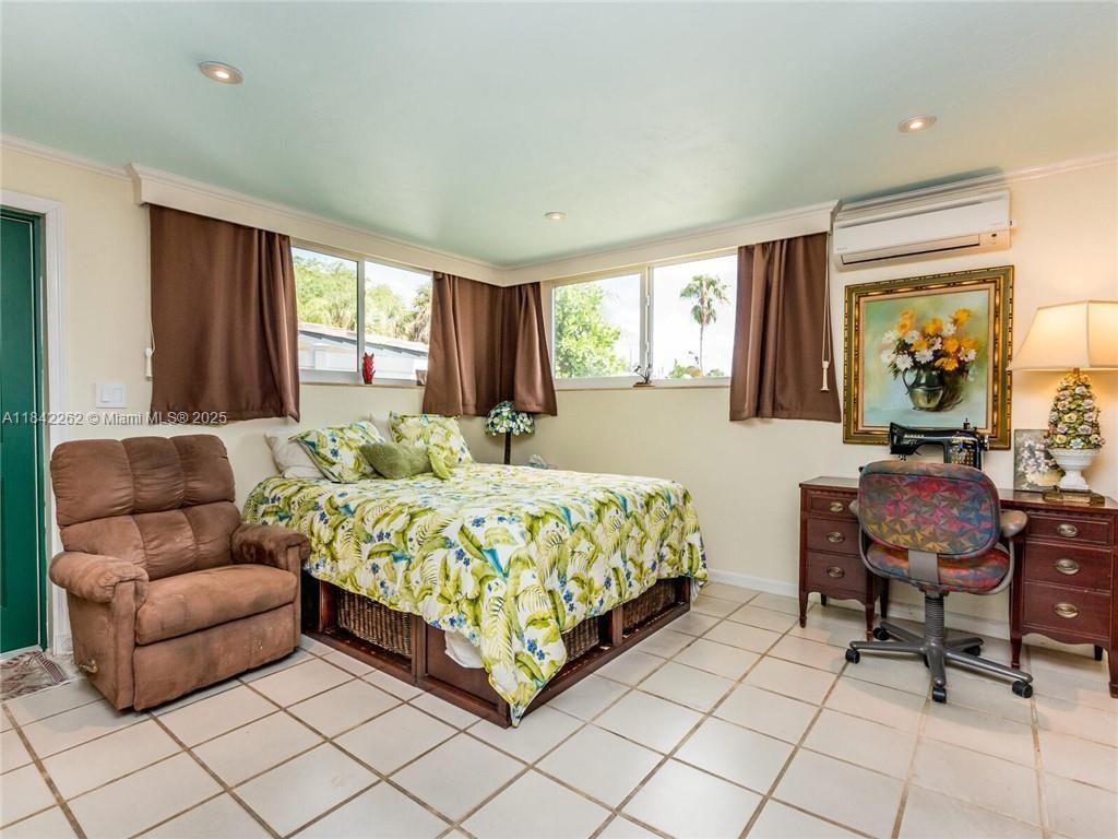 2616 Northeast 26th Avenue Lighthouse Point, FL 33064 - Photo 23 of 30 a bedroom with a bed and a large window