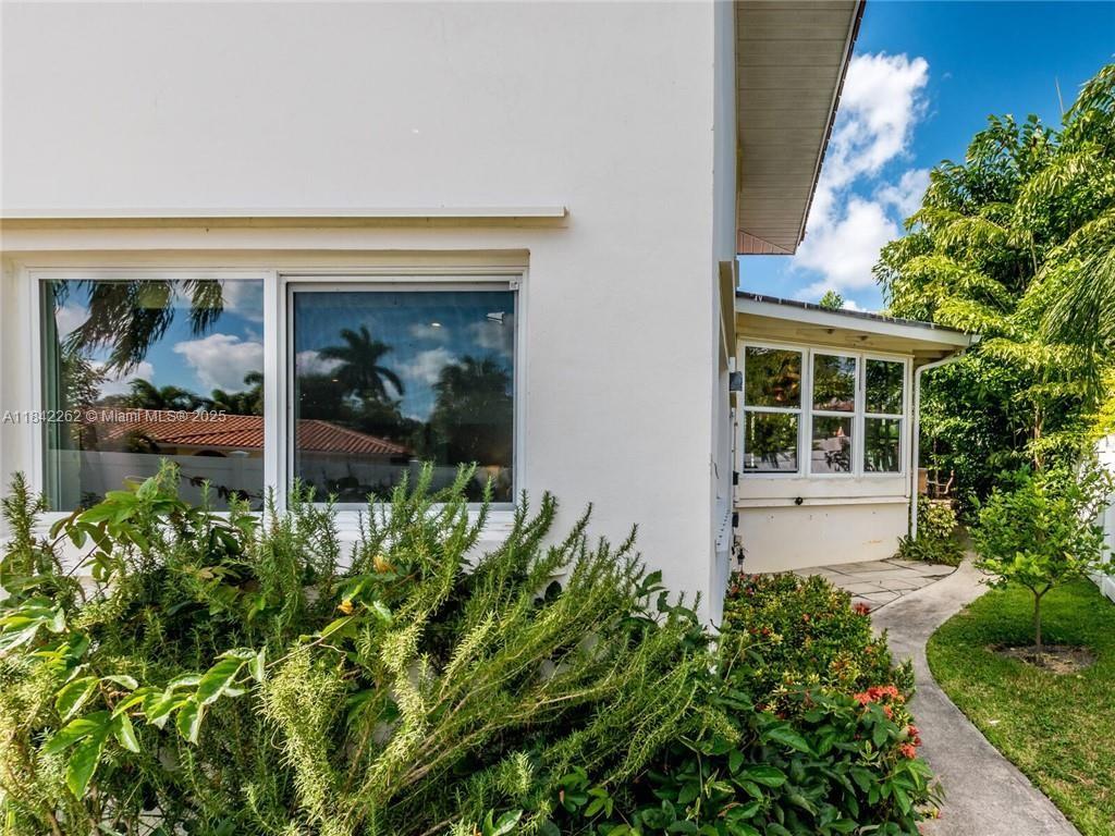 2616 Northeast 26th Avenue Lighthouse Point, FL 33064 - Photo 27 of 30 front view of a house with a garden