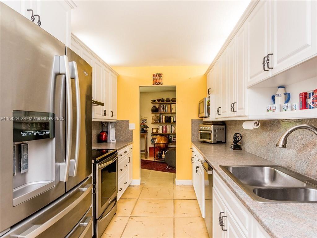 2616 Northeast 26th Avenue Lighthouse Point, FL 33064 - Photo 9 of 30 a kitchen with a sink and cabinets
