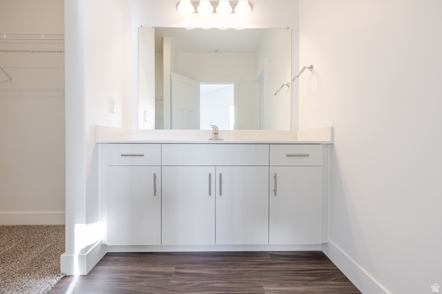 4662 Poplar Way, Unit Q302 Mapleton, UT 84664 - Photo 5 of 17 Bathroom with vanity, a walk in closet, and dark wood finished floors