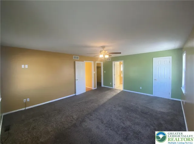 a view of an empty room with a fireplace