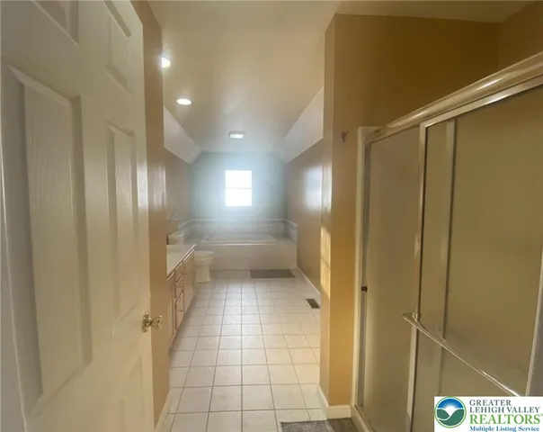 a bathroom with a glass shower door