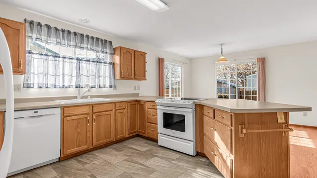 a kitchen with stainless steel appliances granite countertop a stove and a sink