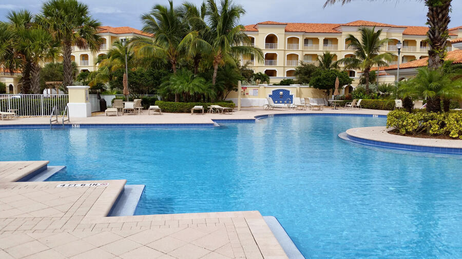 a view of a swimming pool with a lawn chairs