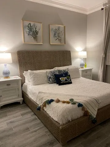 a bedroom with bed and painting on the wall