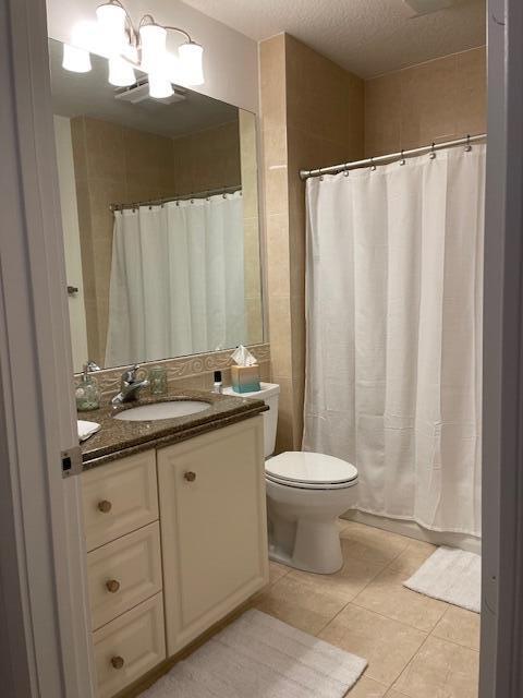 16 Harbour Isle Drive West, Unit 304 Fort Pierce, FL 34949 - Photo 13 of 17 a bathroom with a toilet a sink and a mirror