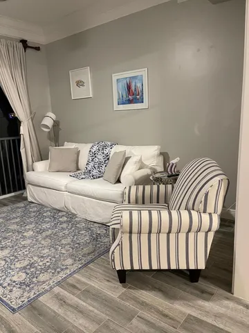 a living room with a couch and a wooden floor