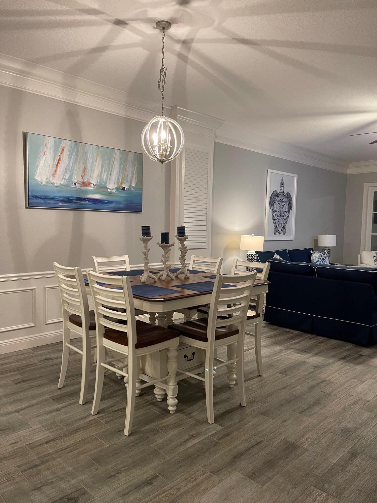 16 Harbour Isle Drive West, Unit 304 Fort Pierce, FL 34949 - Photo 16 of 17 a view of a dining room with furniture wooden floor and chandelier