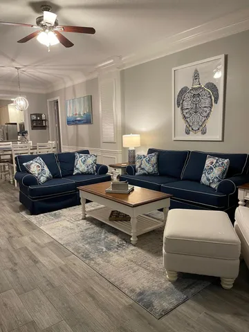 a living room with furniture and a lamp