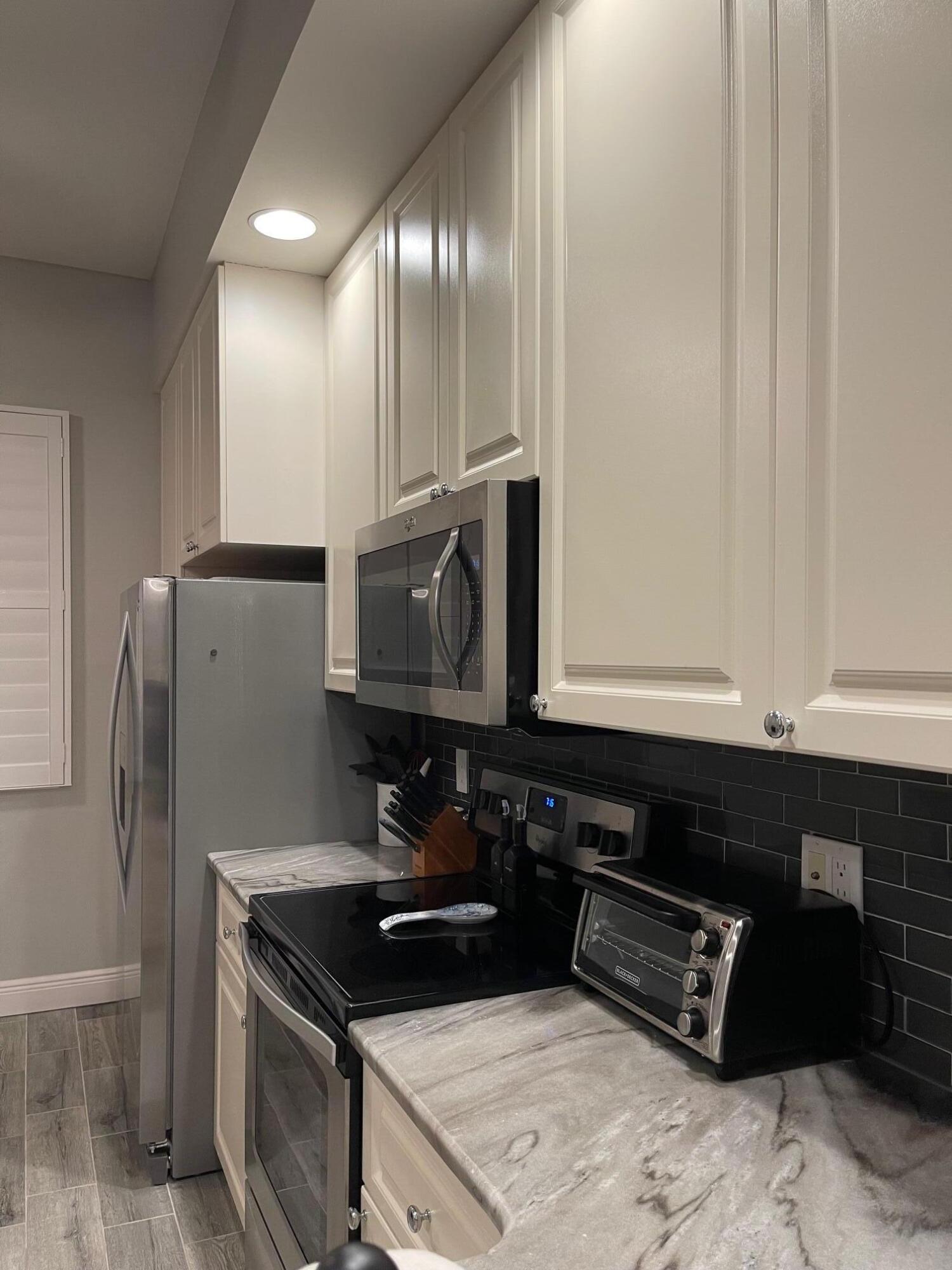 16 Harbour Isle Drive West, Unit 304 Fort Pierce, FL 34949 - Photo 5 of 17 a kitchen with stainless steel appliances granite countertop a refrigerator and a sink