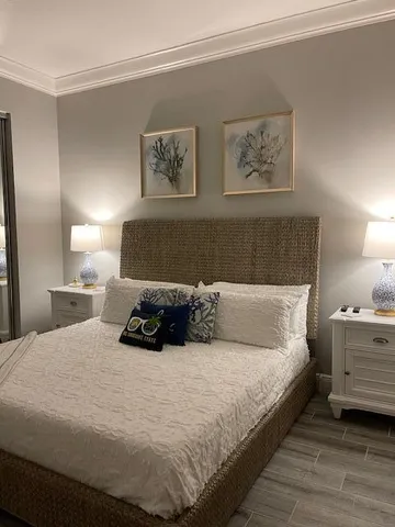a bedroom with a bed and wall painting