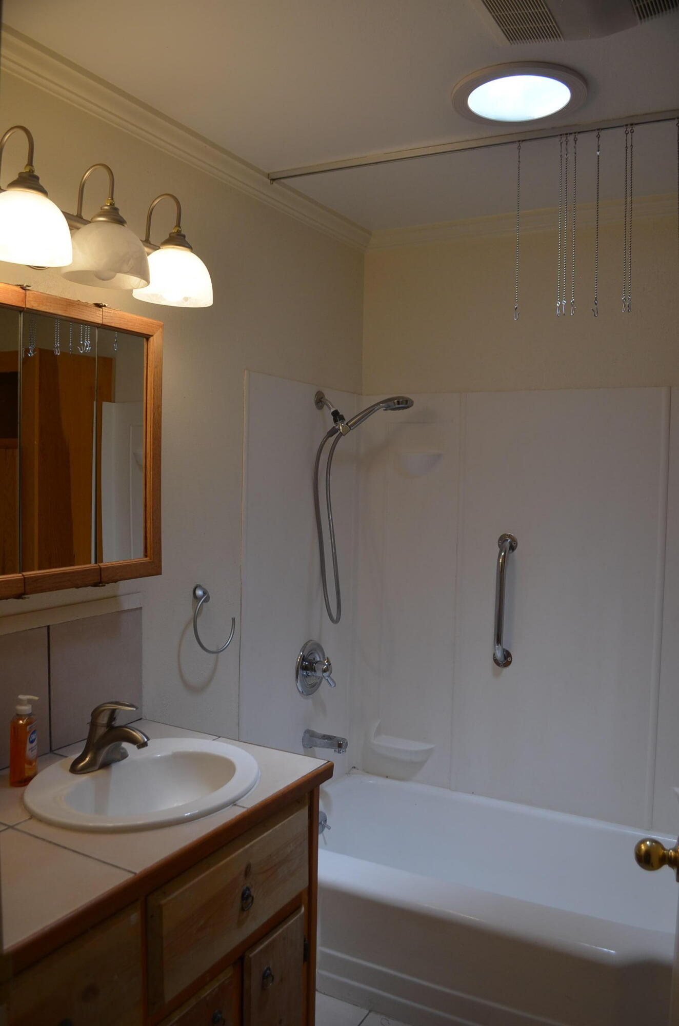 137008 Main Street Crescent, OR 97733 - Photo 25 of 50 a bathroom with a sink a light fixture and a toilet