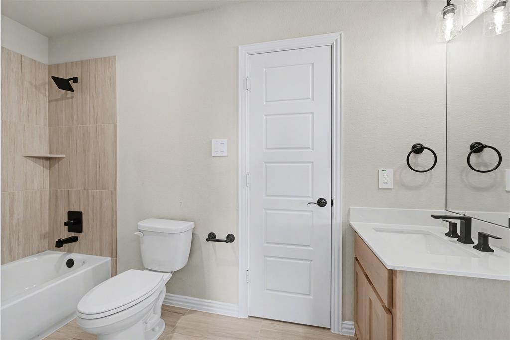 7041 Champion Road Midlothian, TX 76065 - Photo 27 of 30 a bathroom with a sink a toilet and shower