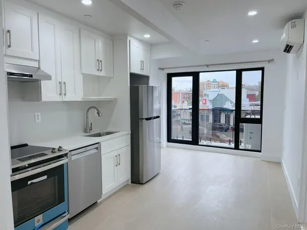 a kitchen with stainless steel appliances granite countertop a stove and a refrigerator