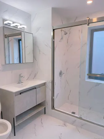 a bathroom with a double vanity sink mirror and shower