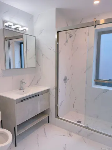 a bathroom with a double vanity sink mirror and shower