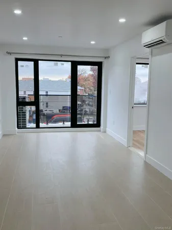 an empty room with large windows