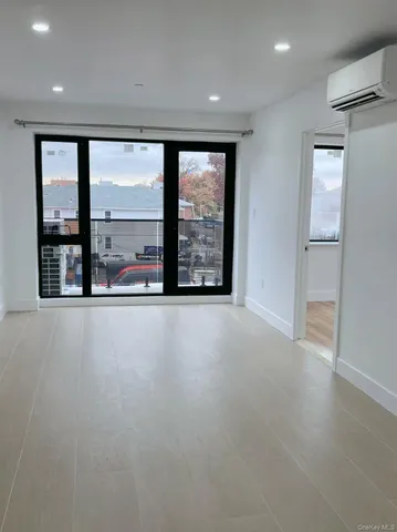 an empty room with large windows