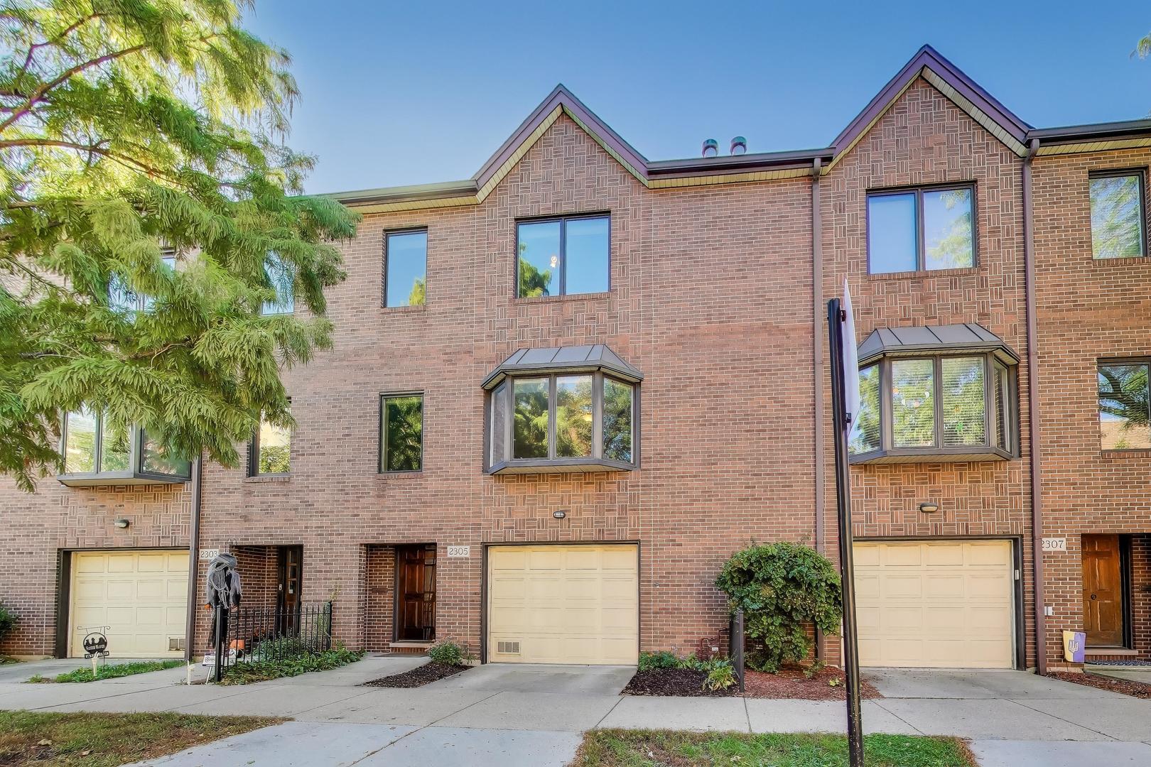 2305 West Thomas Street, Unit 1 Chicago, IL 60622 - Photo 1 of 34 a front view of a house with a yard and garage