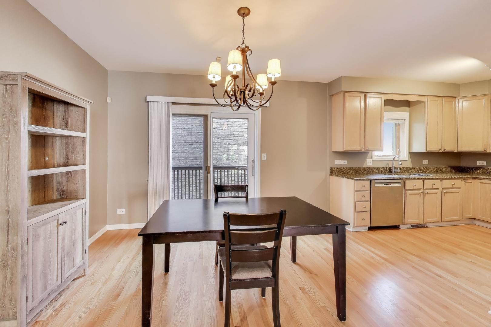 2305 West Thomas Street, Unit 1 Chicago, IL 60622 - Photo 12 of 34 a dining room with wooden floor and breakfast area