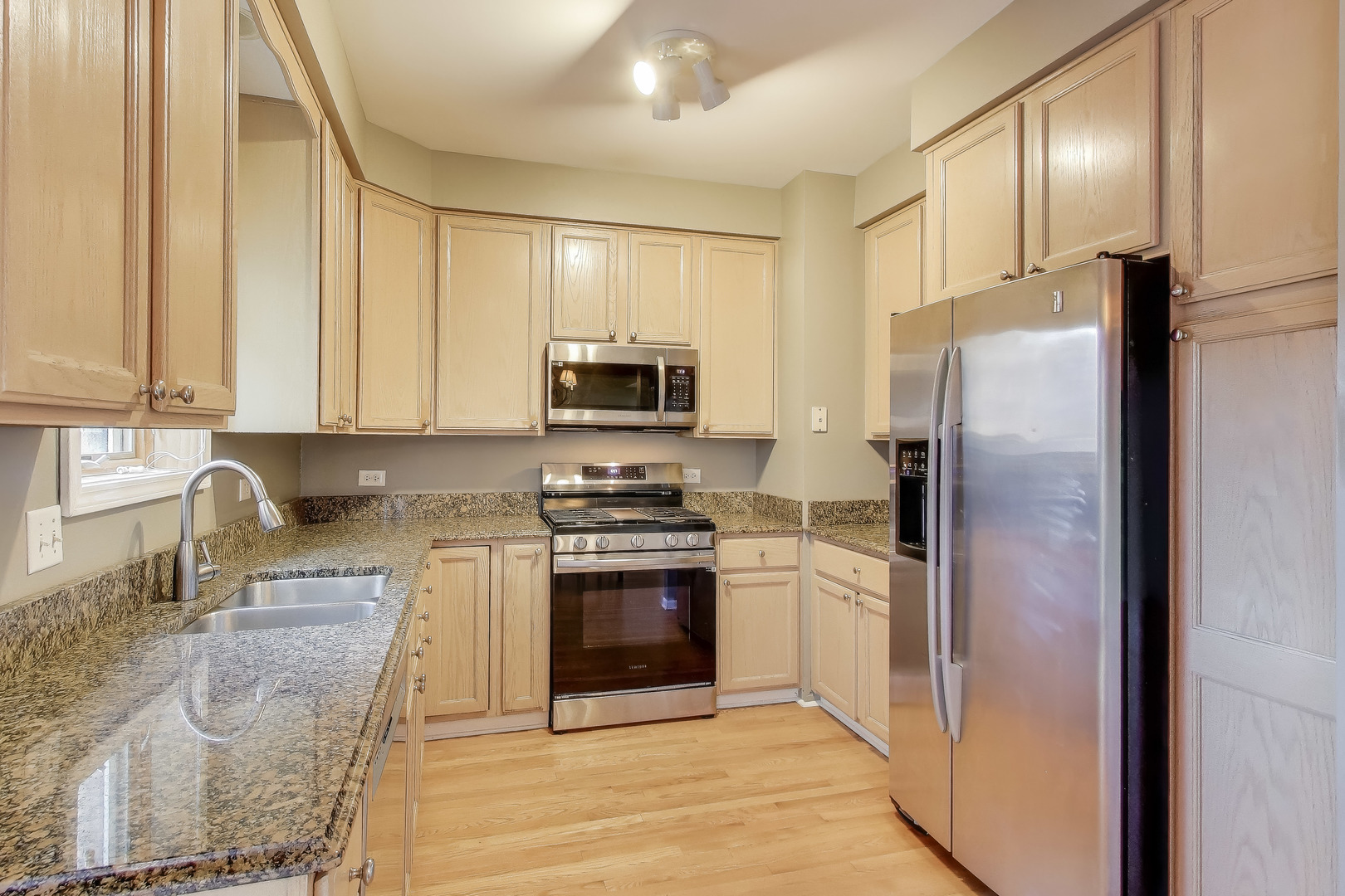 2305 West Thomas Street, Unit 1 Chicago, IL 60622 - Photo 13 of 34 a kitchen with stainless steel appliances granite countertop a refrigerator stove and sink
