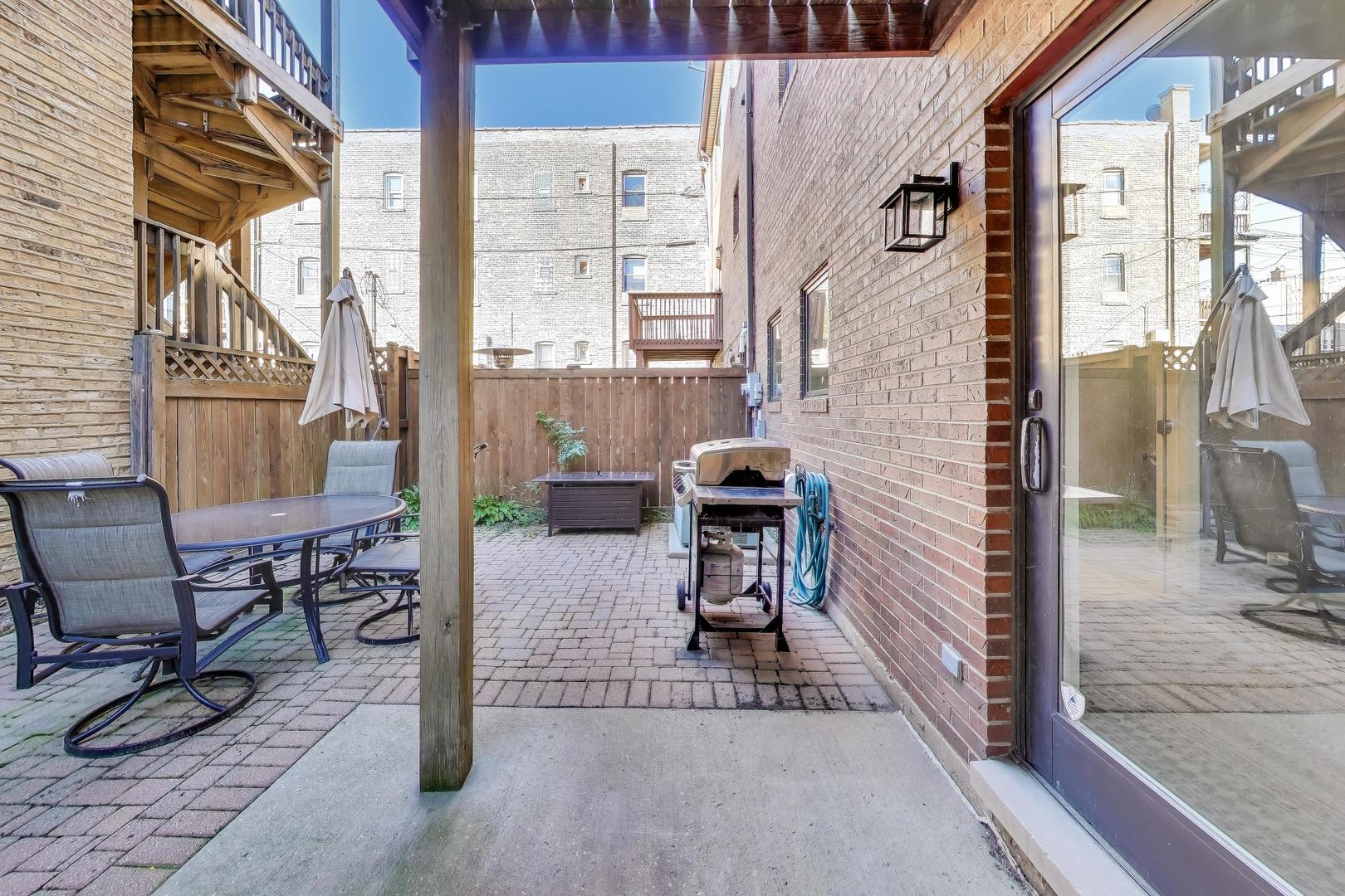 2305 West Thomas Street, Unit 1 Chicago, IL 60622 - Photo 27 of 34 a view of a porch with chairs and table in the patio