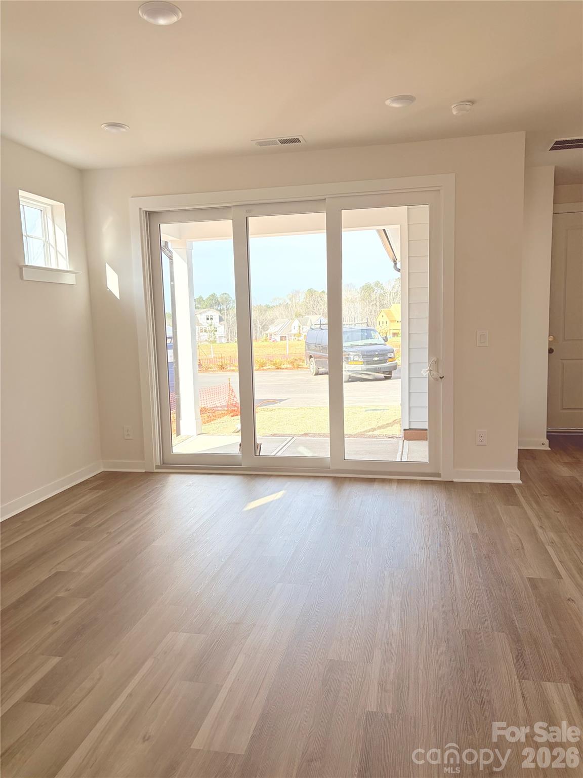 5214 Holw Br Road Charlotte, NC 28278 - Photo 16 of 17 an empty room with wooden floor and windows