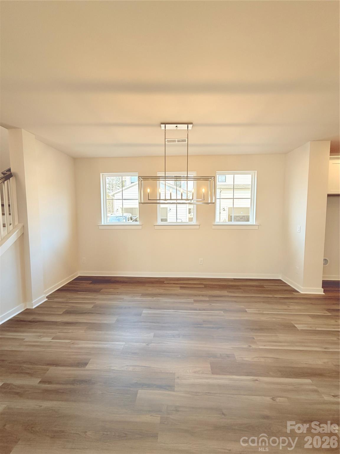 5214 Holw Br Road Charlotte, NC 28278 - Photo 5 of 17 a view of an empty room with wooden floor and a window
